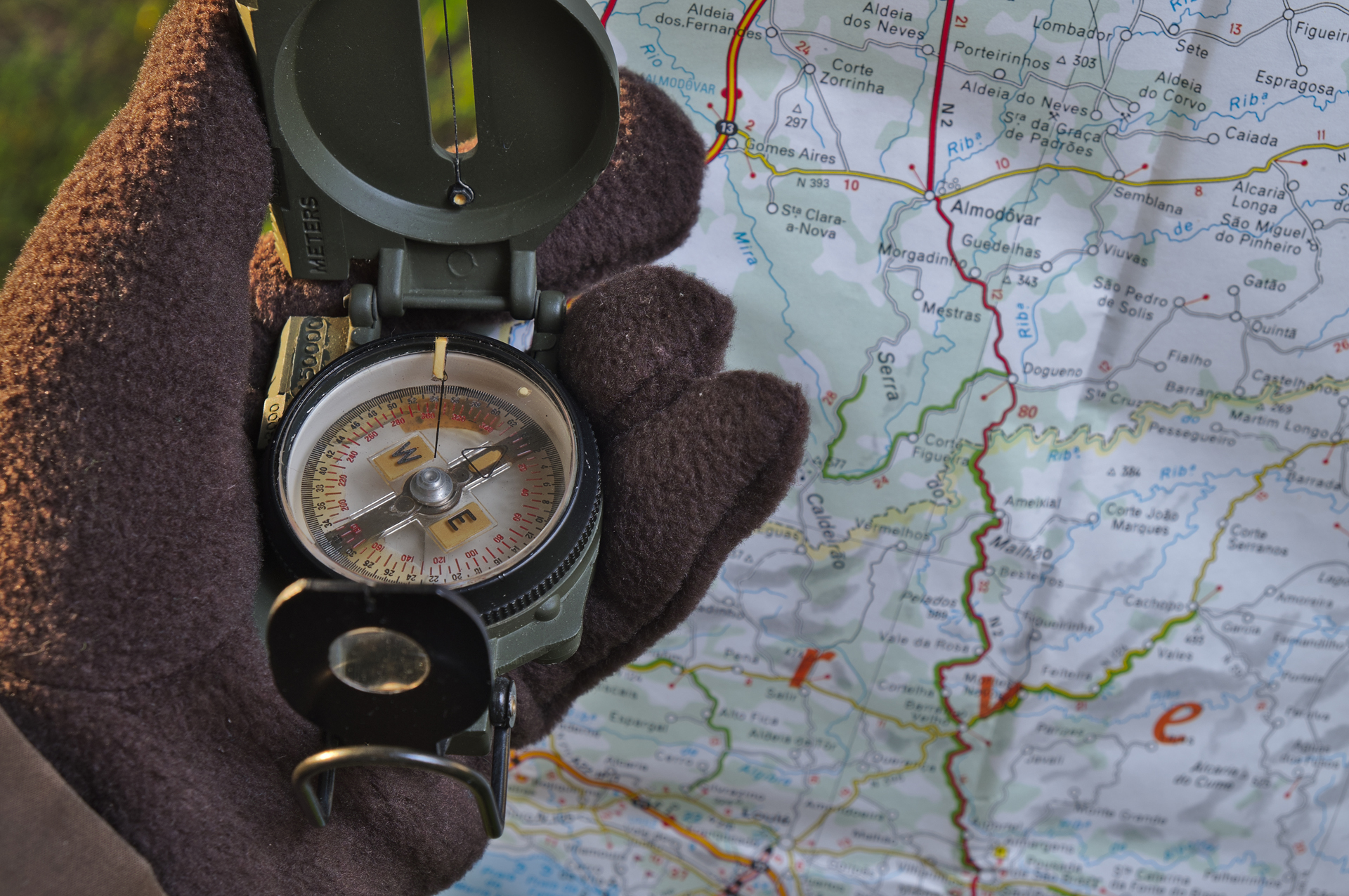 Compass in hand with Map in background